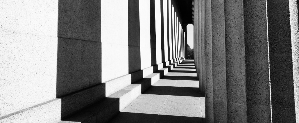 Black and white columns and shadows outside of a building demonstrate how the world can look different in black and white, a way to help kids focus and develop observation skills